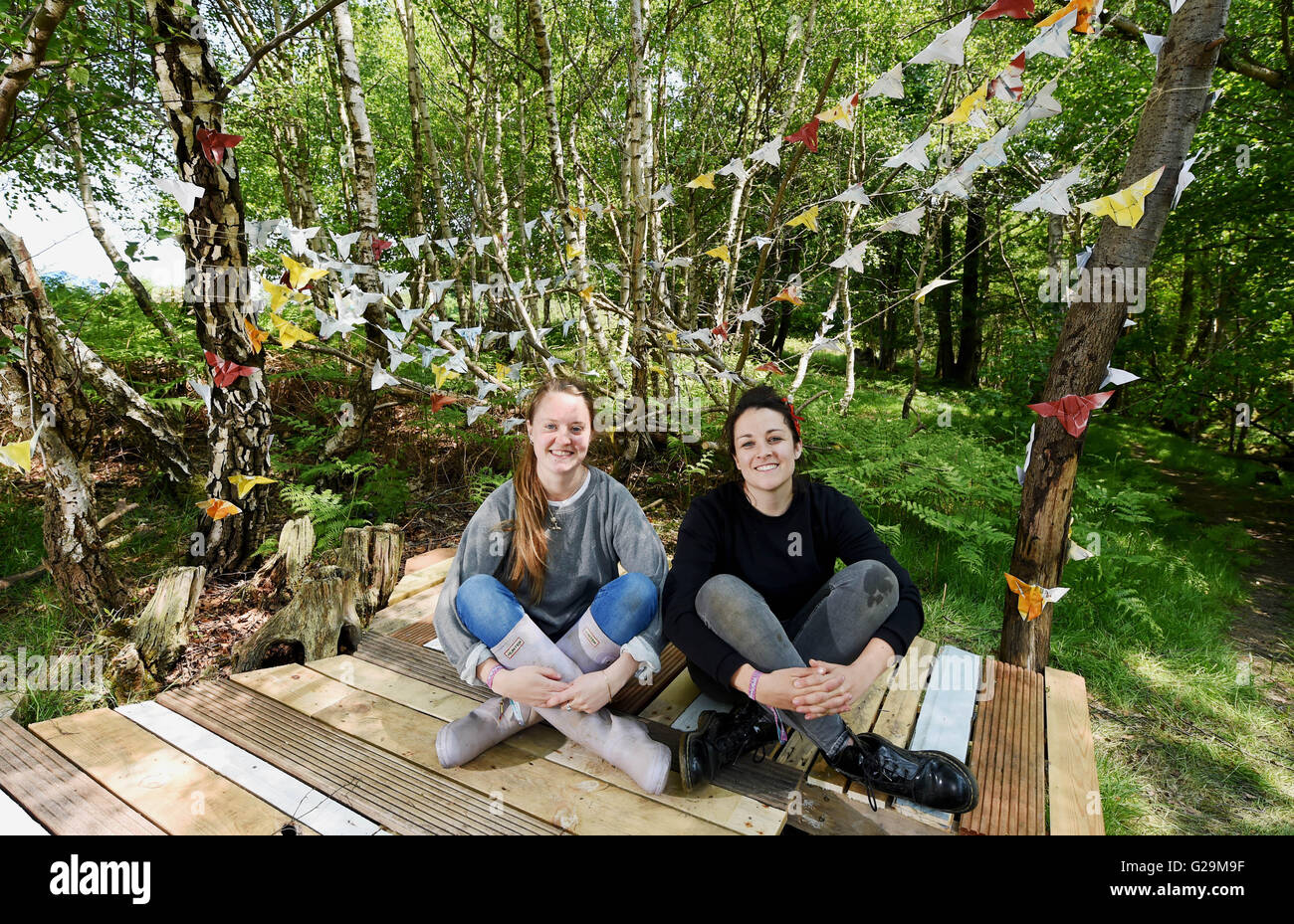 Nutley, East Sussex, UK. 27th May, 2016.  Tasha O'Byrne (left) and Josephine Neill take a break from preparing the art installation 'Flights of May'at the Elderflower Fields Festival held at Pippingford Park in Nutley Sussex this weekend . Elderflower Fields is a small independent family festival held over the next three days  Credit:  Simon Dack/Alamy Live News Stock Photo
