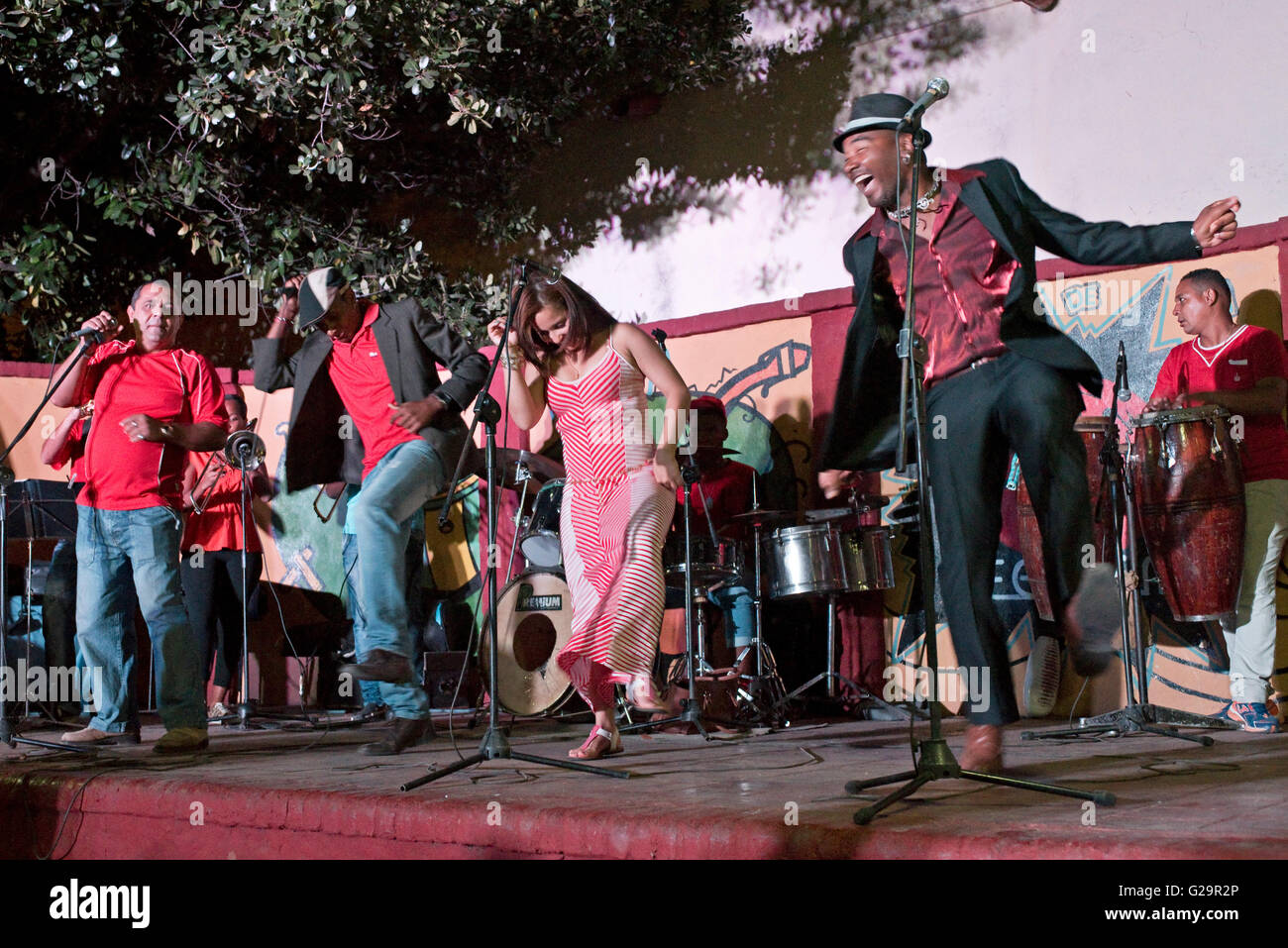 Cuban musicians in a group playing and singing salsa for locals and tourists at the Casa de la Músíca in Trinidad, Cuba. Stock Photo