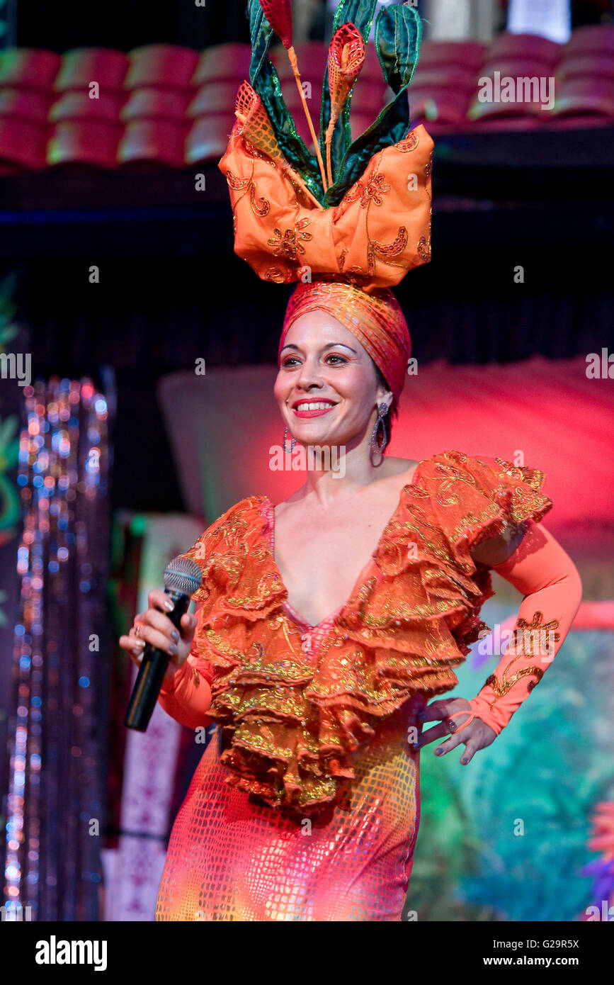 A Cuban Salsa singer in colourful traditional dress performing on stage at a hotel in Varadero. Stock Photo