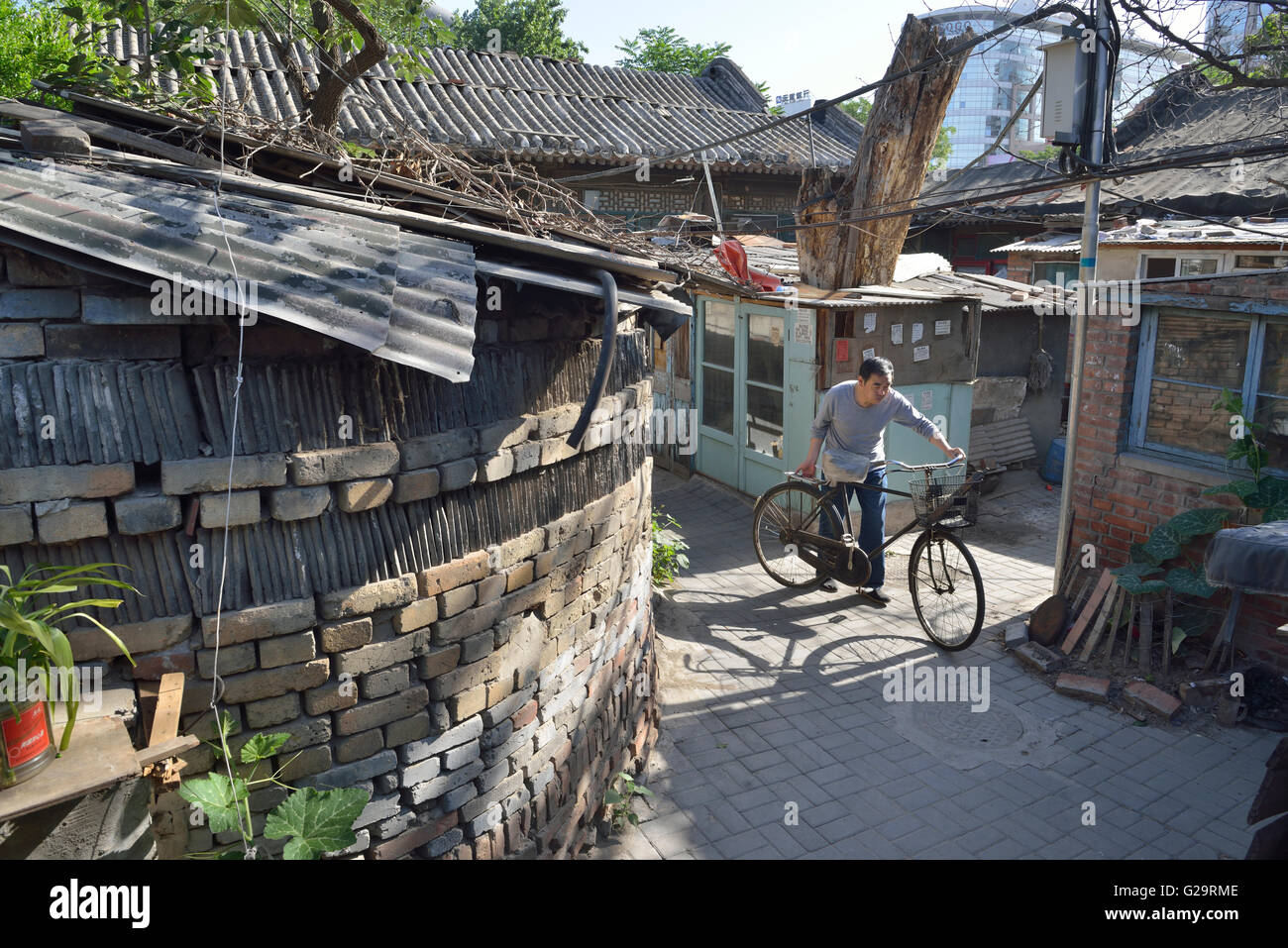 A man is making final preparations to move away from his house in the historic Temple of Yang Jiaoshan in Beijing, China. Stock Photo