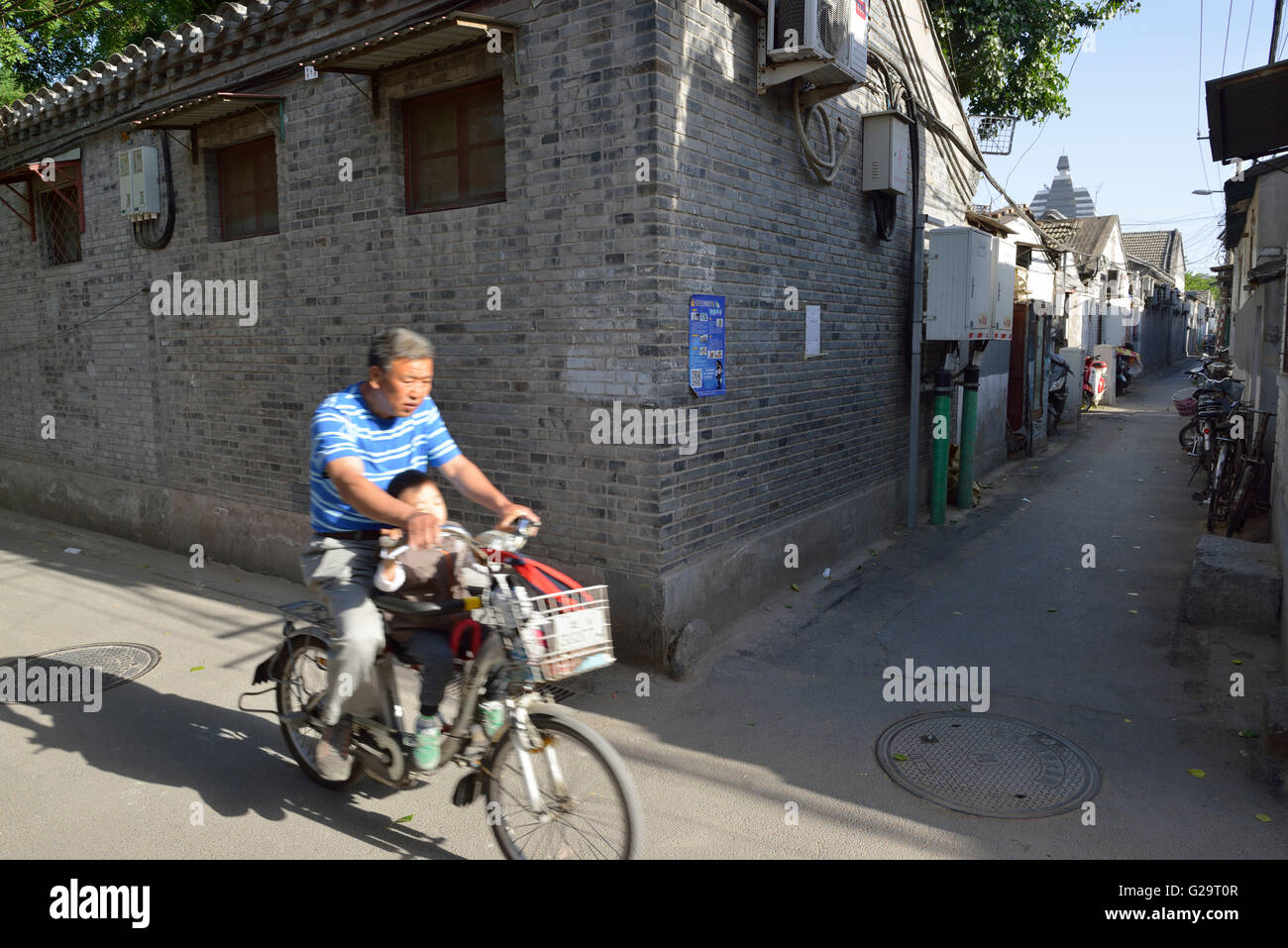 People drives bicycles at Hutong in Beijing, China. Stock Photo