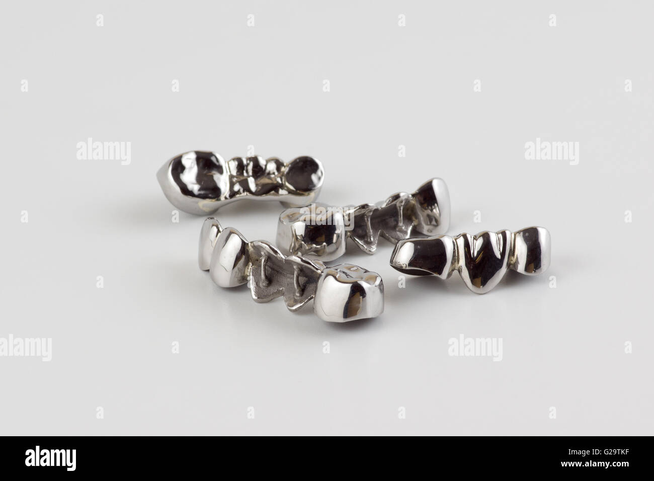 steel dentures made in dental laboratory on a white background Stock Photo