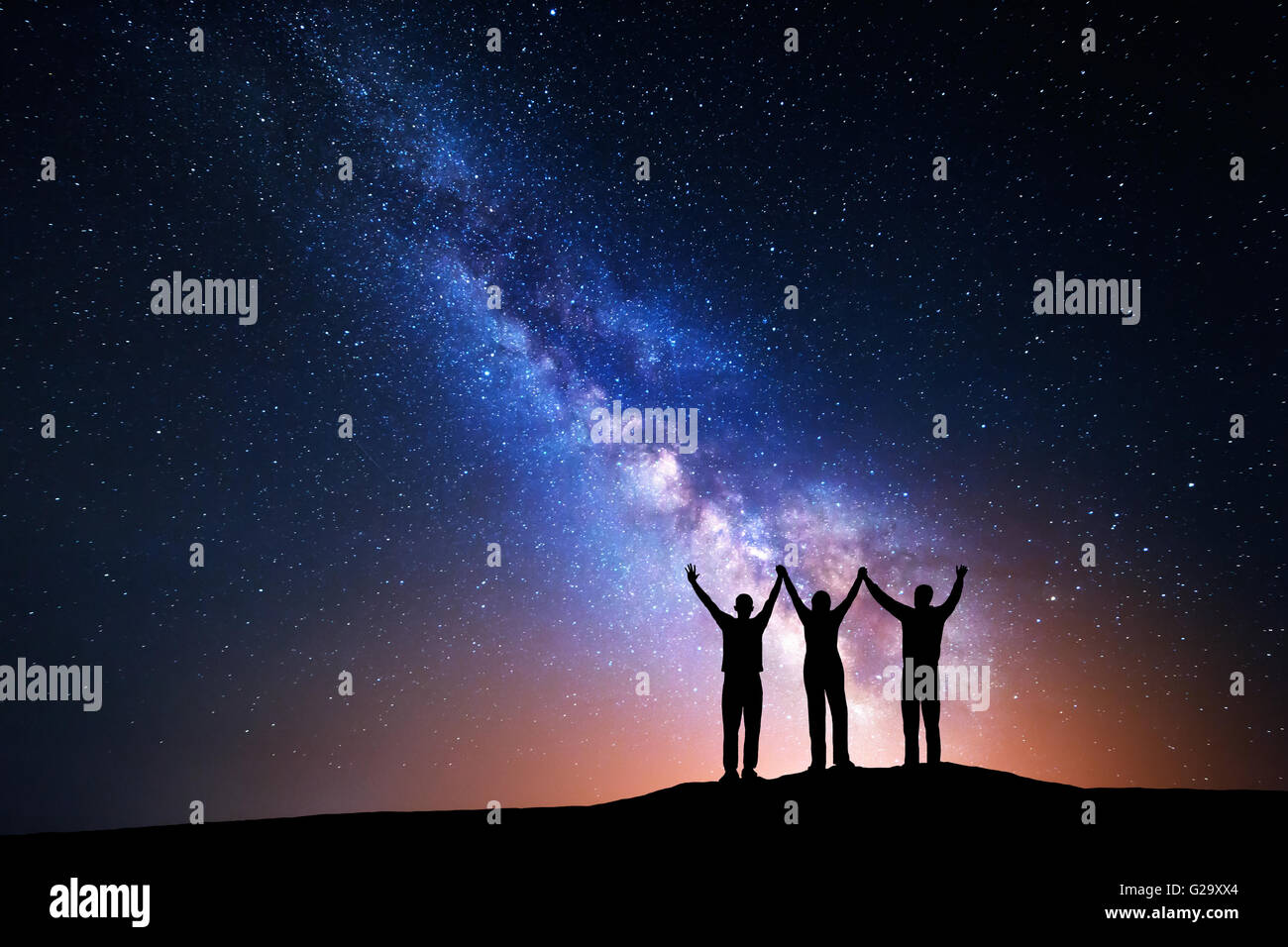 Landscape with colorful Milky Way and silhouette of a happy family with ...