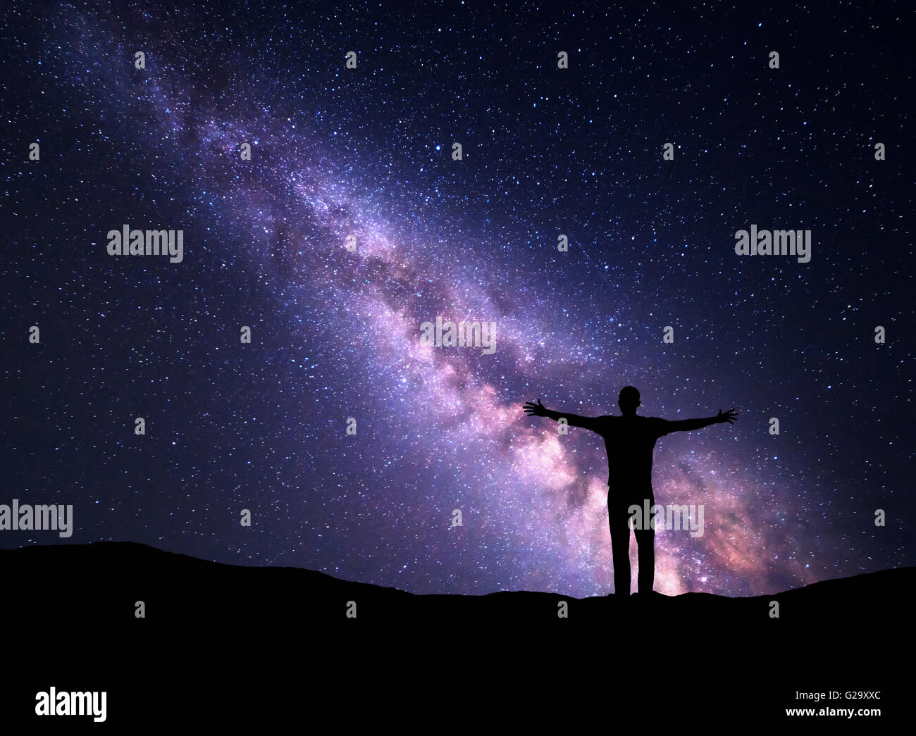 Night colorful landscape with Milky Way and silhouette of a standing ...