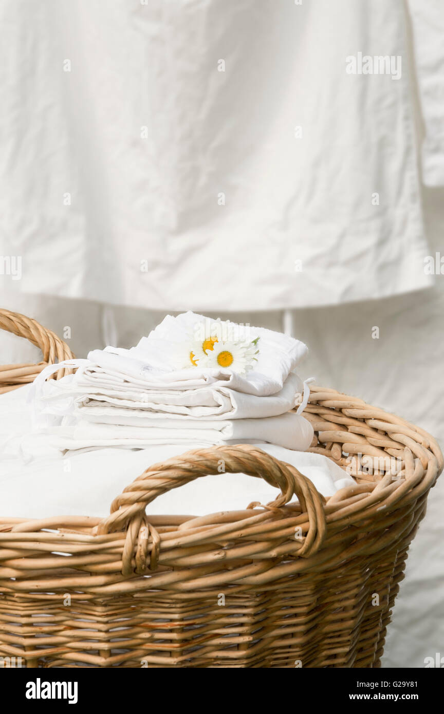 Basket full of clean freshly washed grandmother's linens. Stock Photo