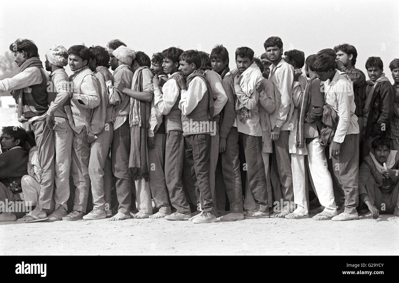 [Image: a-group-of-indian-men-line-up-outside-a-...G29YCY.jpg]
