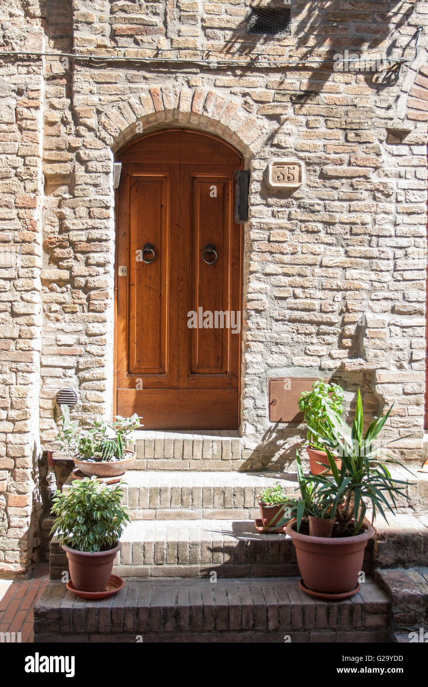 Typical wooden door entry in medieval village San Gimignano Tuscany Italy Stock Photo