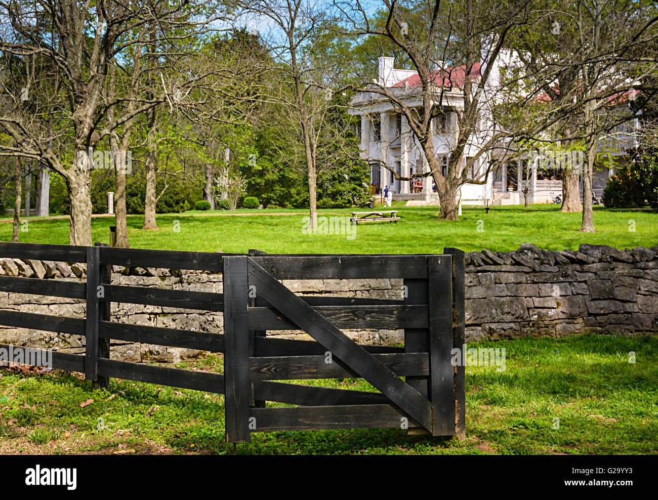 Tourists enjoy the Belle Meade Plantation Mansion surrounded by old rock walls and wooden fences in Nashville, TN, USA Stock Photo
