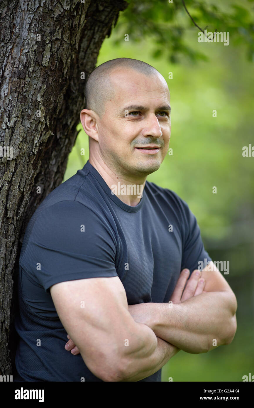 Closeup of an European man outdoor with arms folded Stock Photo