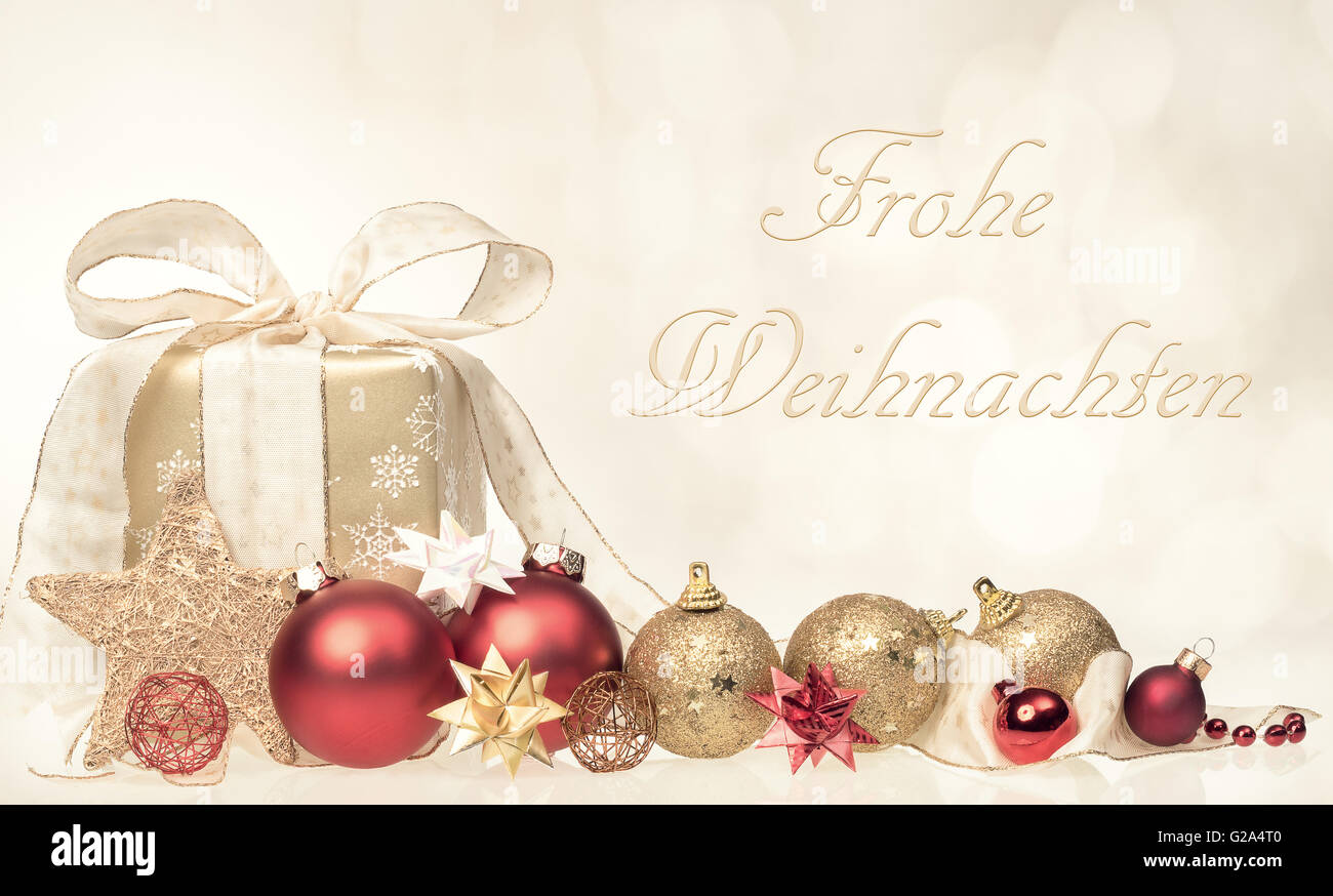 Christmas gift box and balls with grettins text Frohe Weihnachten Stock Photo