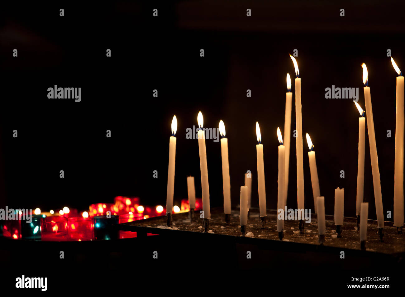 Many burning prayer candles in catholic church Stock Photo Alamy