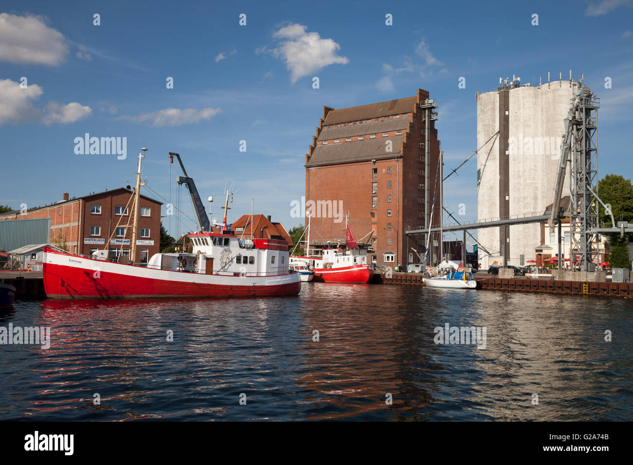 Fishing boats and granaries in the fishing port, Burgstaaken, Fehmarn island, Schleswig-Holstein, Germany Stock Photo