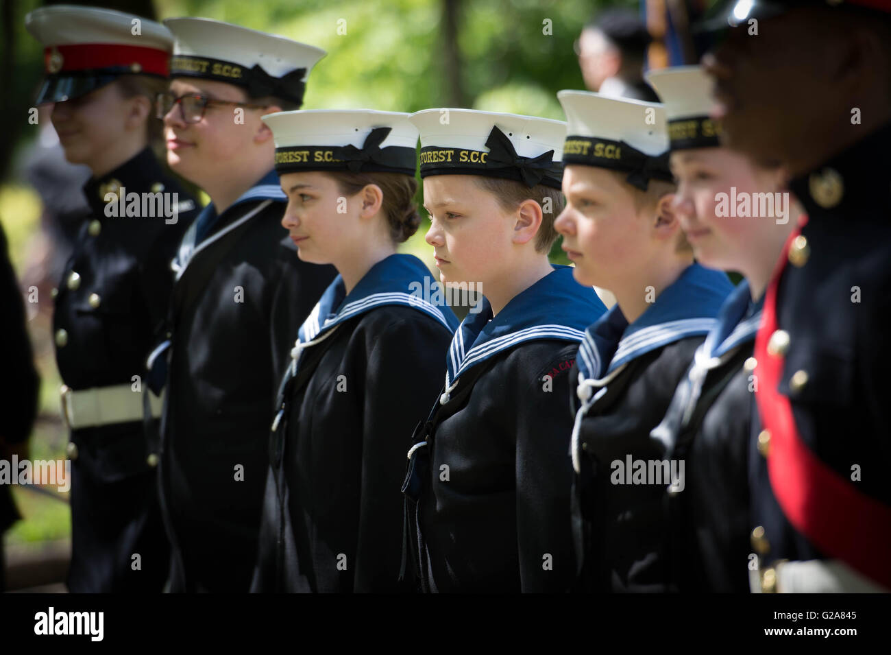 Members of the Royal Navy and Royal Marines cadets stand during a commemoration event for sixteen year old Jack Cornwell at Coronation Gardens, in Waltham Forest, east London, where a memorial paving stone was unveiled at the war memorial, Jack was posthumously awarded the Victoria Cross following his death 100 years ago, during the Battle of Jutland. Stock Photo
