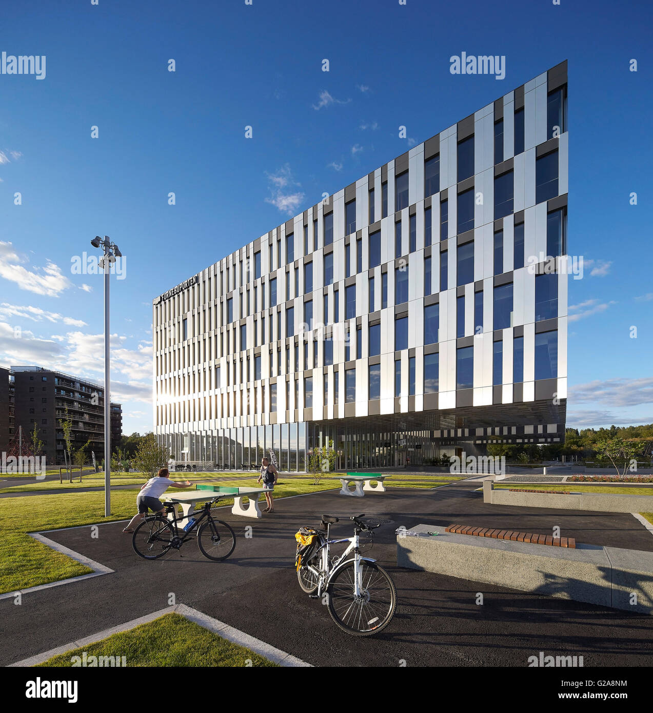 Table tennis players in action with building beyond. Fornebuporten, Oslo, Norway. Architect: DARK, 2015. Stock Photo