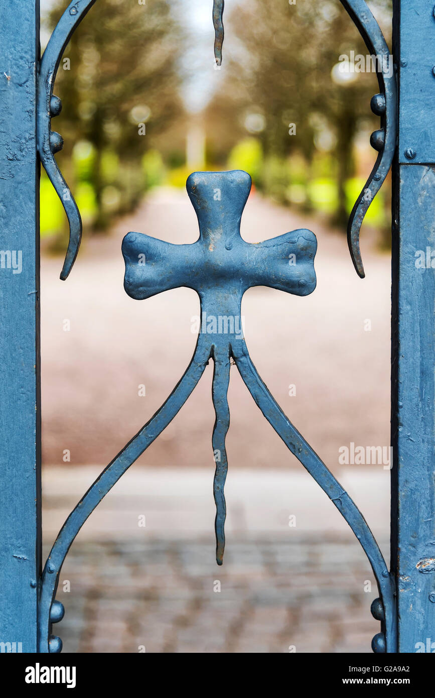 Close up view of a decorative gate that secures the grounds to a graveyard. Stock Photo