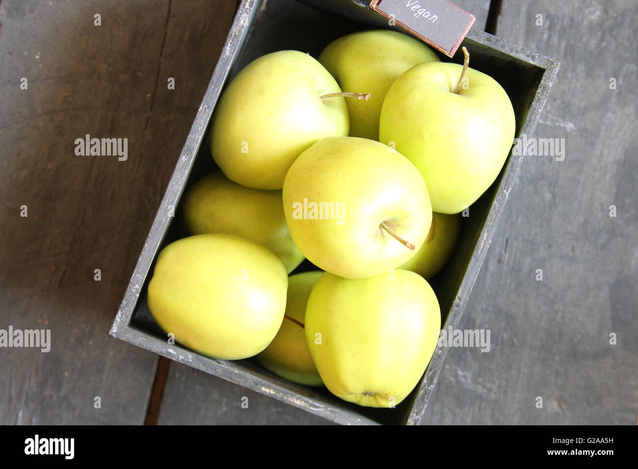 vegan food idea, green apples on a table and text Stock Photo