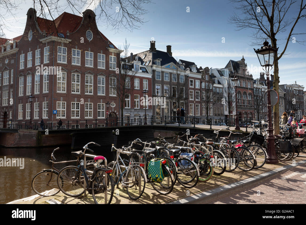Bicycles line a canal in central Amsterdam. Cycling is a popular means of transport within the city. Stock Photo