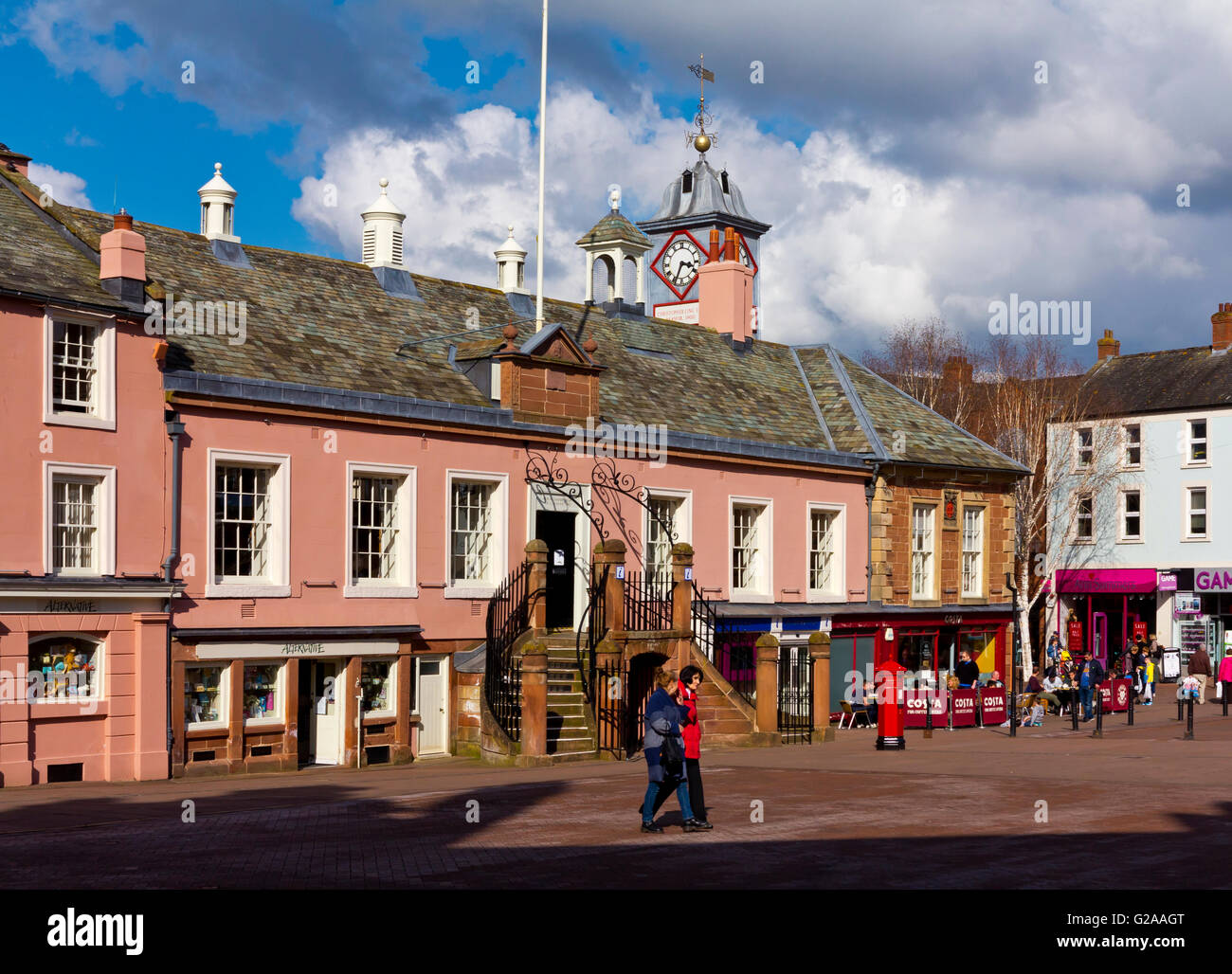 Shoppers walking past the Tourist Information Centre in Carlisle city centre in north Cumbria north west England UK Stock Photo