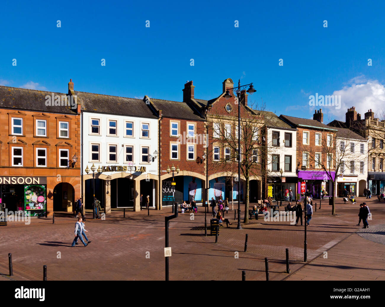 Shoppers in pedestrianised zone in Carlisle city centre in north Cumbria north west England UK Stock Photo