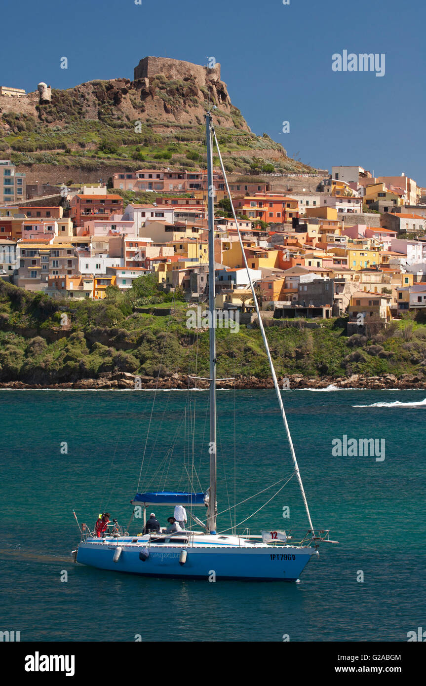 Castelsardo,Sassari,Sardinia,Italy, 10/4/2016.Sailing boat on the sea in front of the colored town of Castelsardo,near the port. Stock Photo