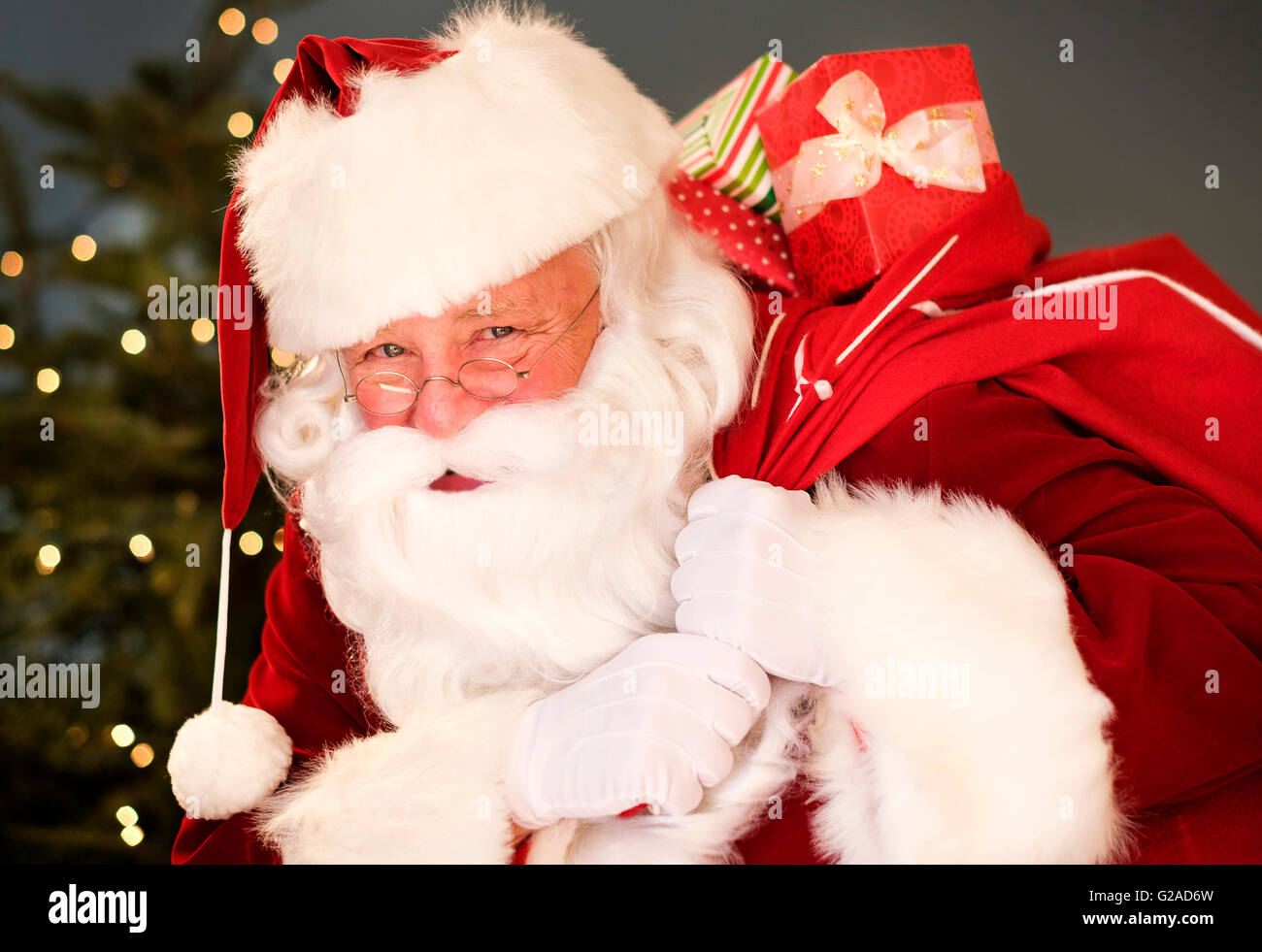 Portrait of Santa Claus carrying sack over shoulder Stock Photo