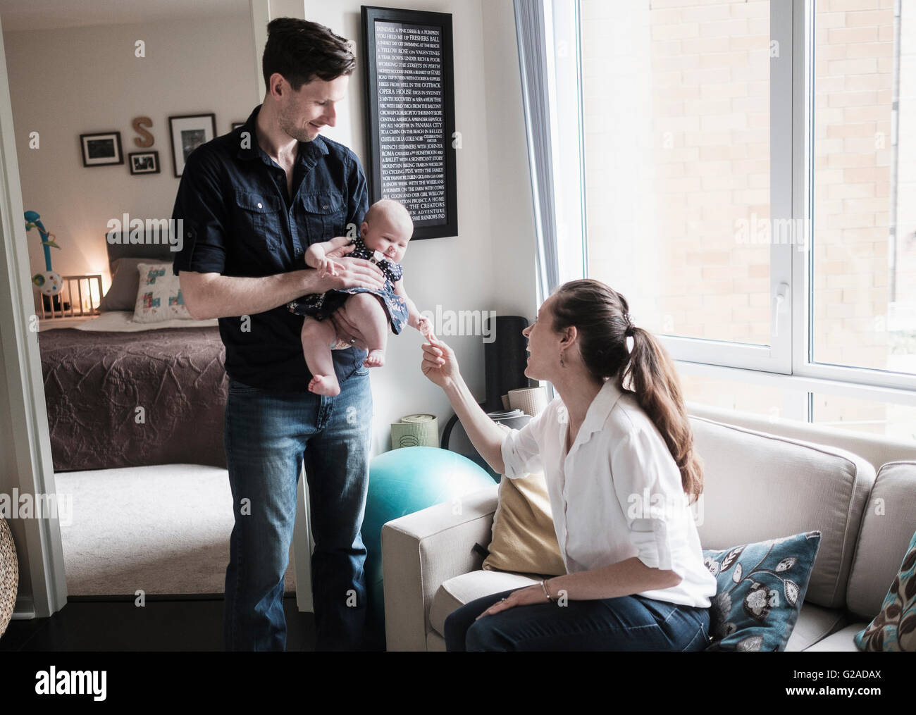 Parents Playing With Baby Daughter 2 5 Months In Living Room Stock parents-playing-with-baby-daughter-2-5-months-in-living-room-stock