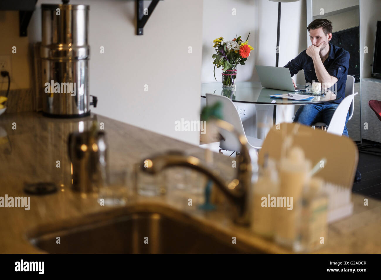 Man working on laptop at home Stock Photo
