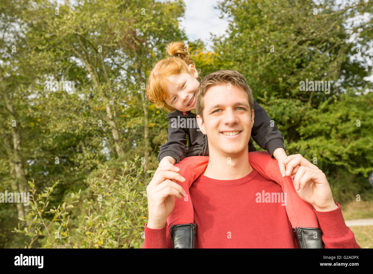Father carrying on shoulders daughter (4-5) Stock Photo
