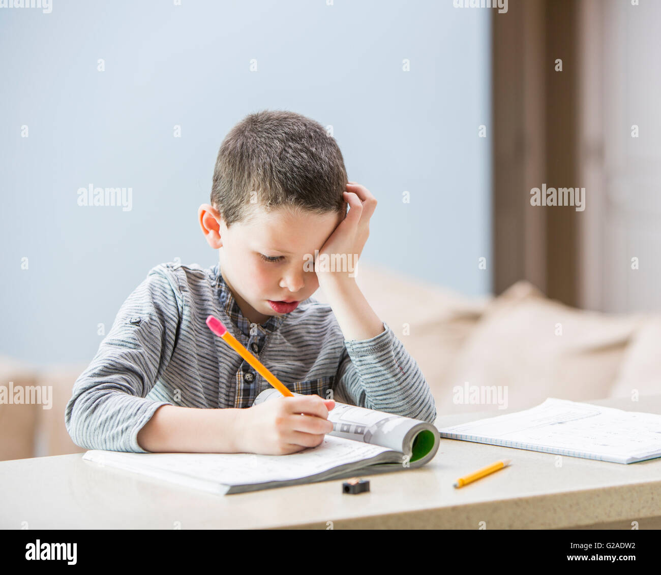 Boy (6-7) doing homework Stock Photo