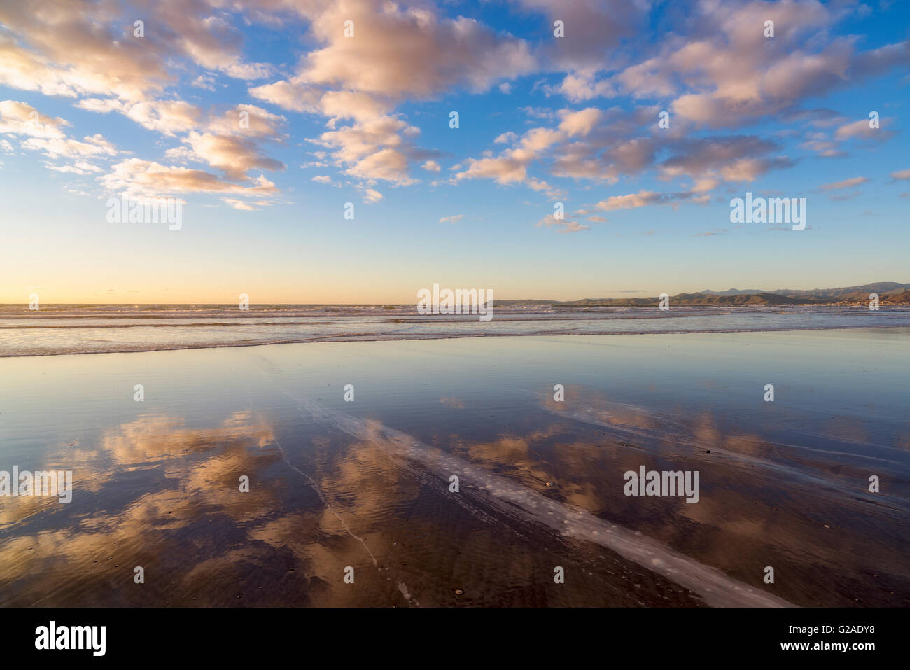 Cloudy sky reflected in sea Stock Photo - Alamy
