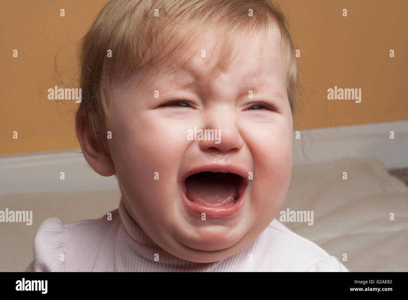 Portrait of baby girl crying Stock Photo - Alamy