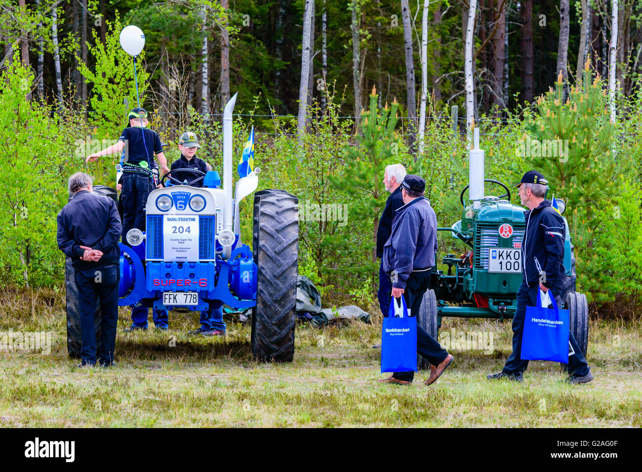 Emmaboda, Sweden - May 14, 2016: Forest and tractor (Skog och traktor) fair. People looking at vintage classic tractors. 1964 Co Stock Photo