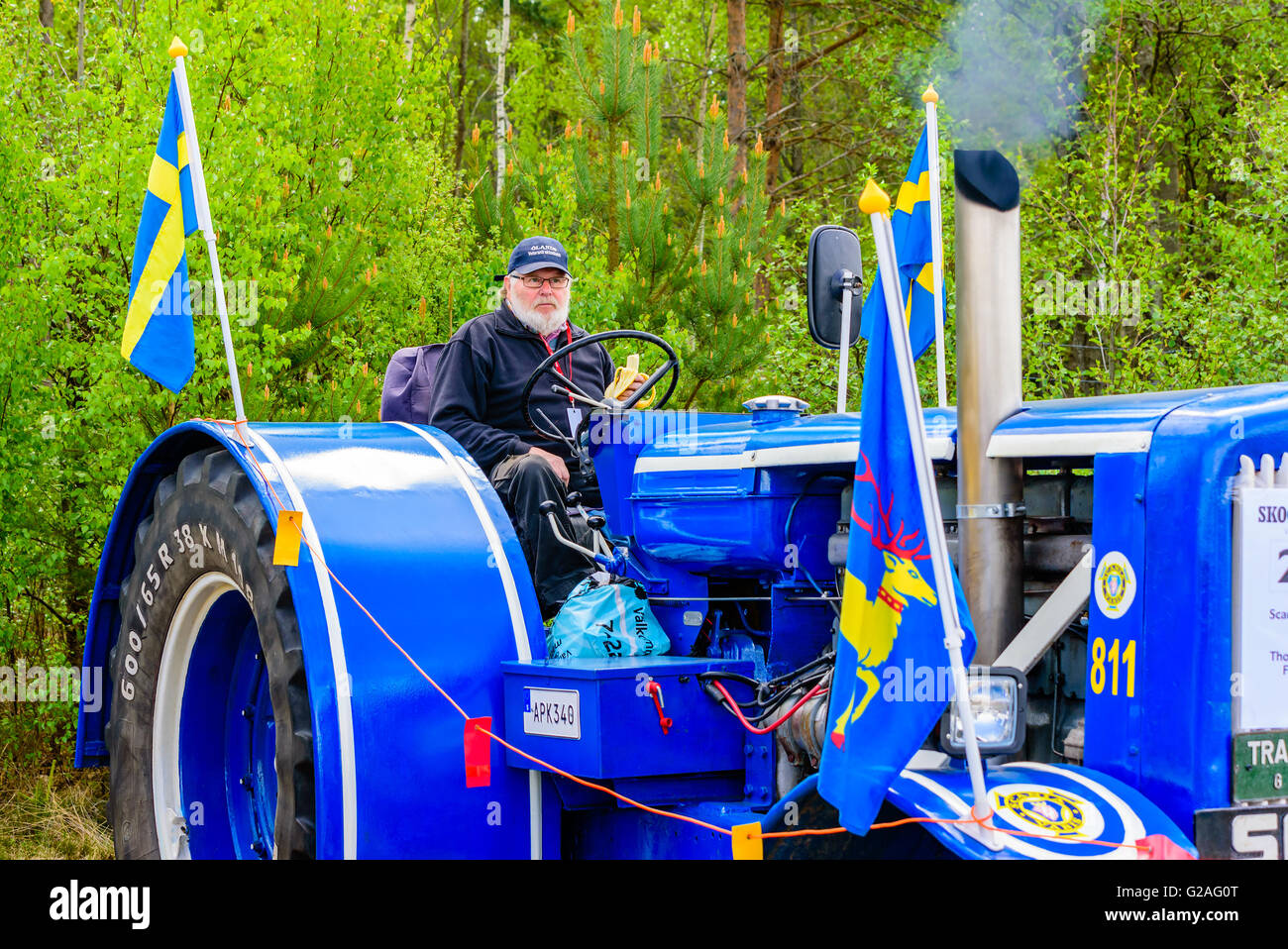 Emmaboda, Sweden - May 14, 2016: Forest and tractor (Skog och traktor) fair. Driver eating a banana while starting the engine of Stock Photo