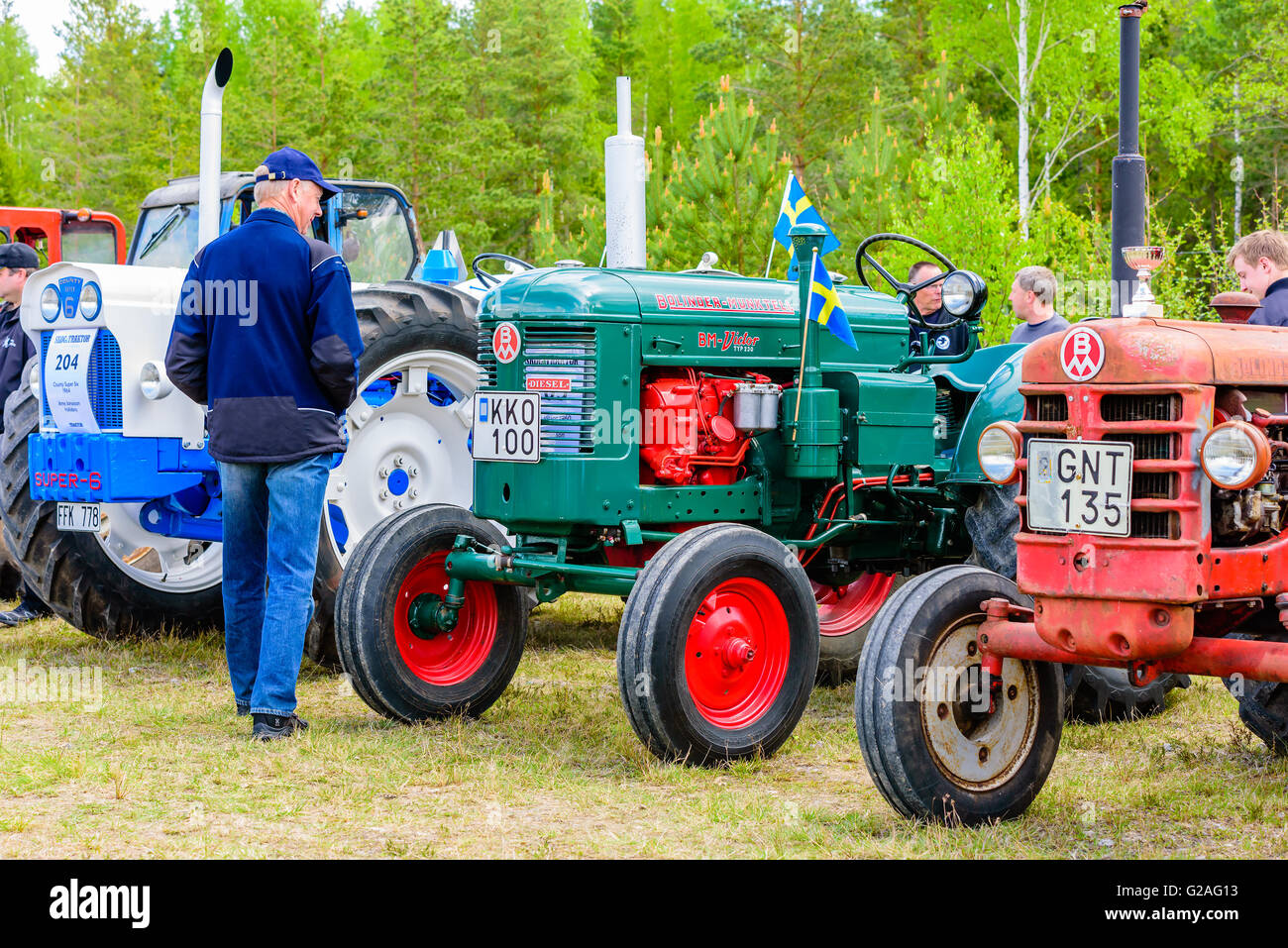 Emmaboda, Sweden - May 14, 2016: Forest and tractor (Skog och traktor) fair. Man looking at vintage classic tractors. Here a gre Stock Photo