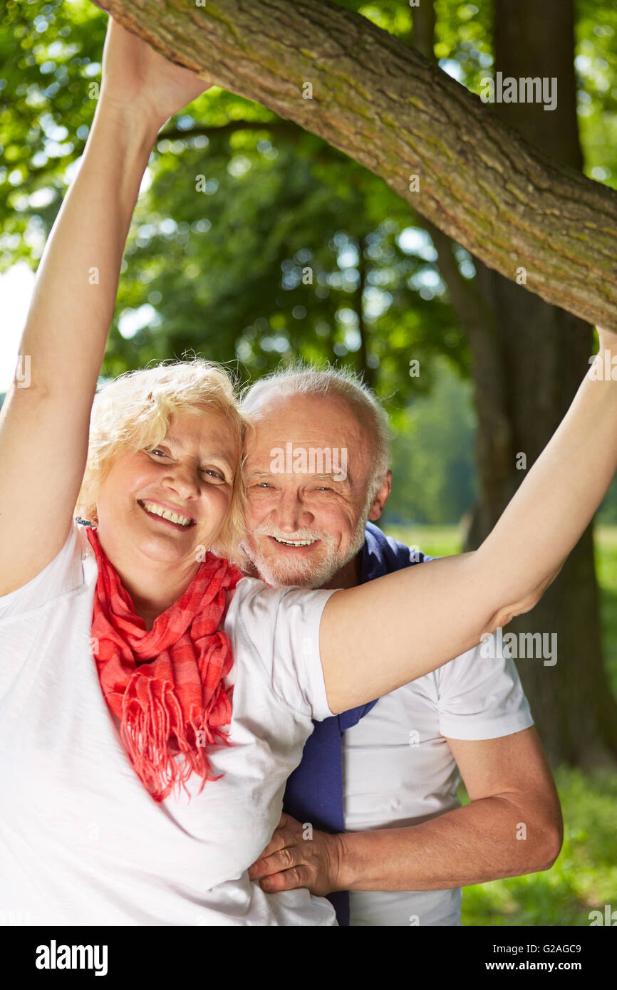 Happy senior couple standing together in a summer garden Stock Photo ...
