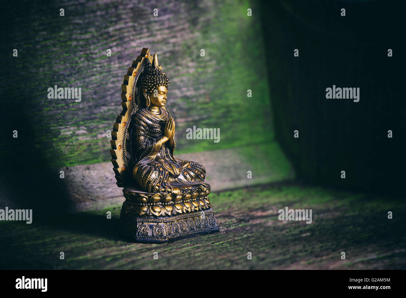 Thai Buddha statue on wood with retro filter Stock Photo