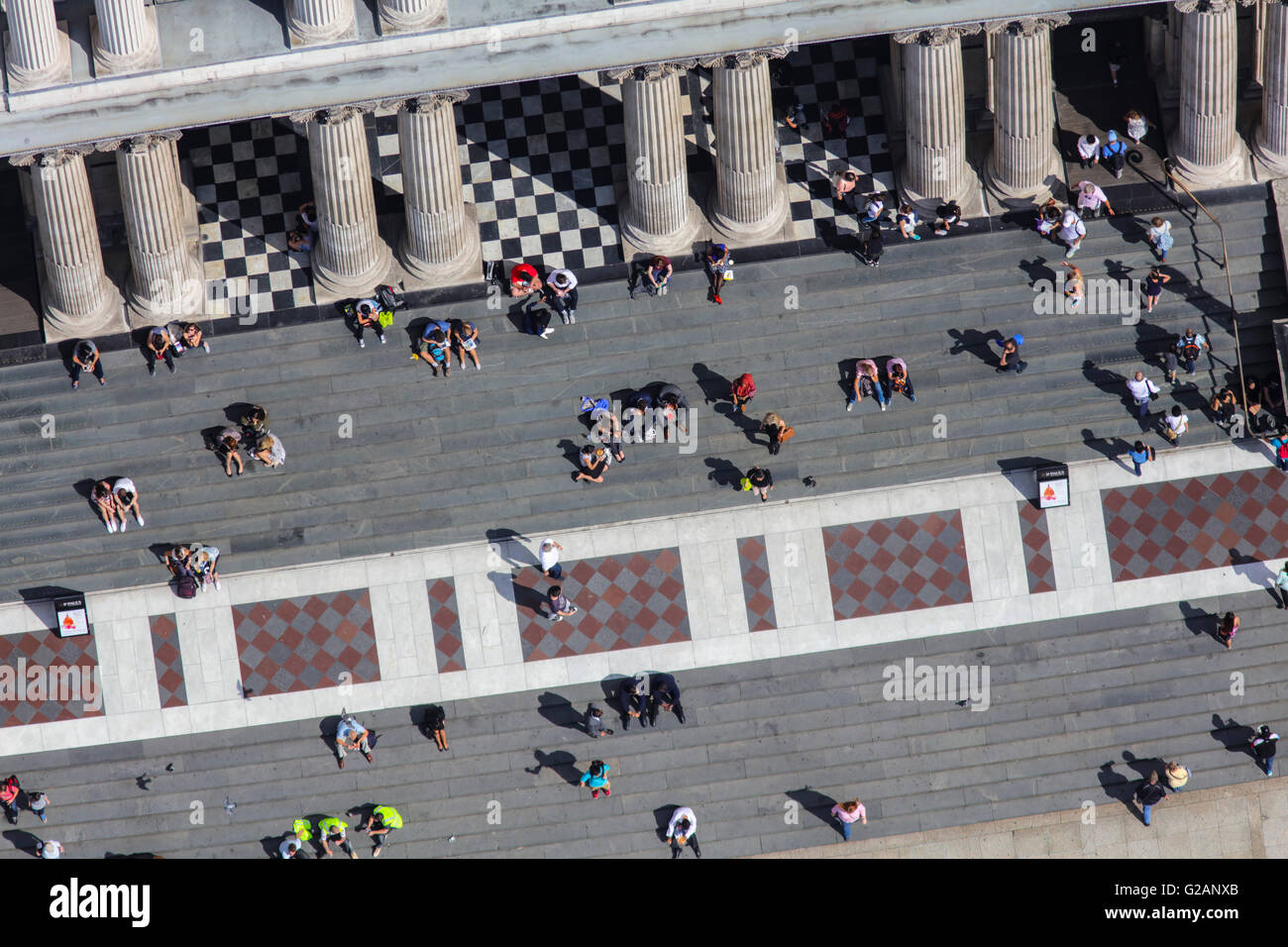 A close up aerial view of people sitting on the steps of St Pauls Cathedral Stock Photo