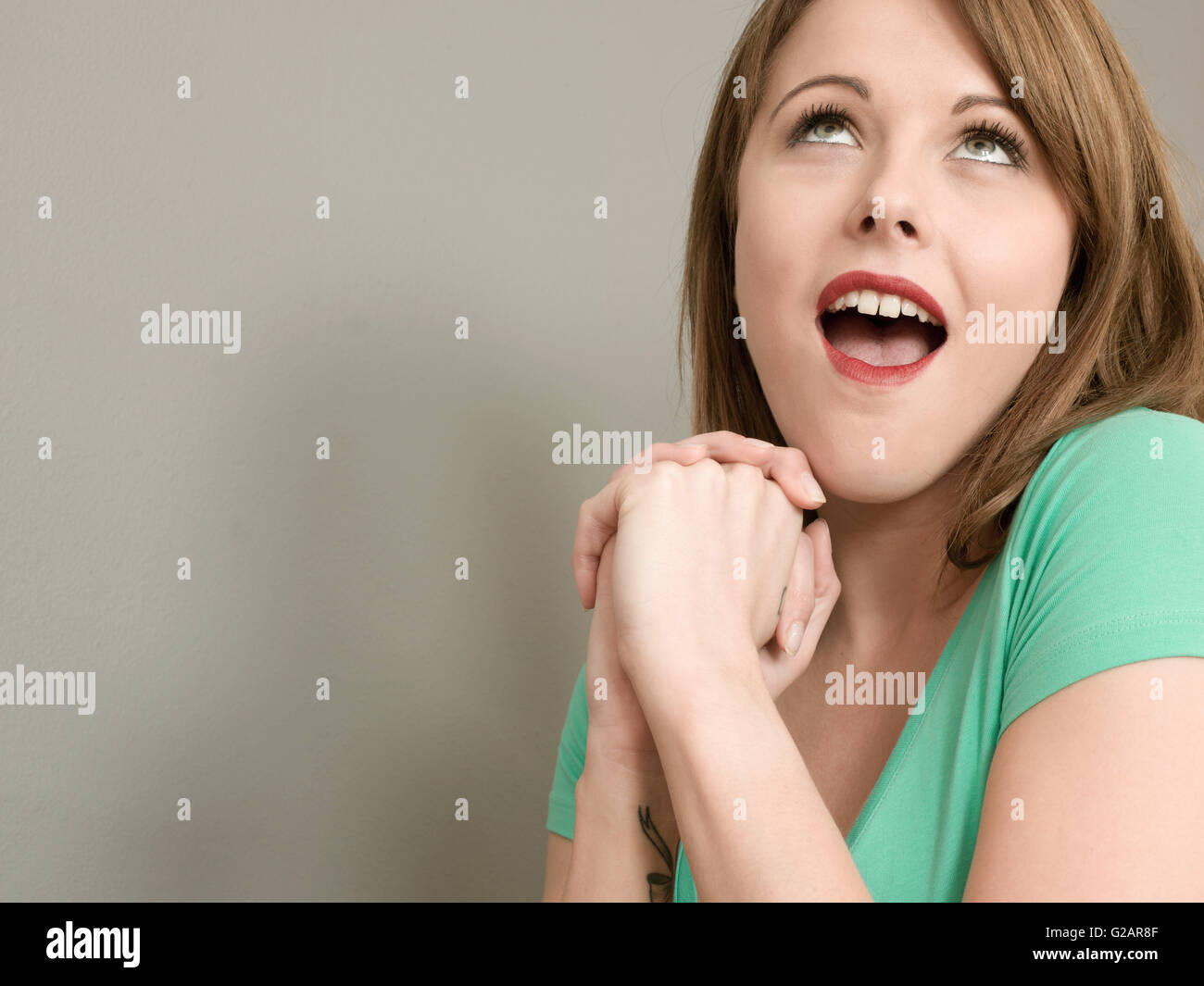 Portrait of an Excited Happy Delighted Young Woman Looking Up Celebrating Good News Stock Photo