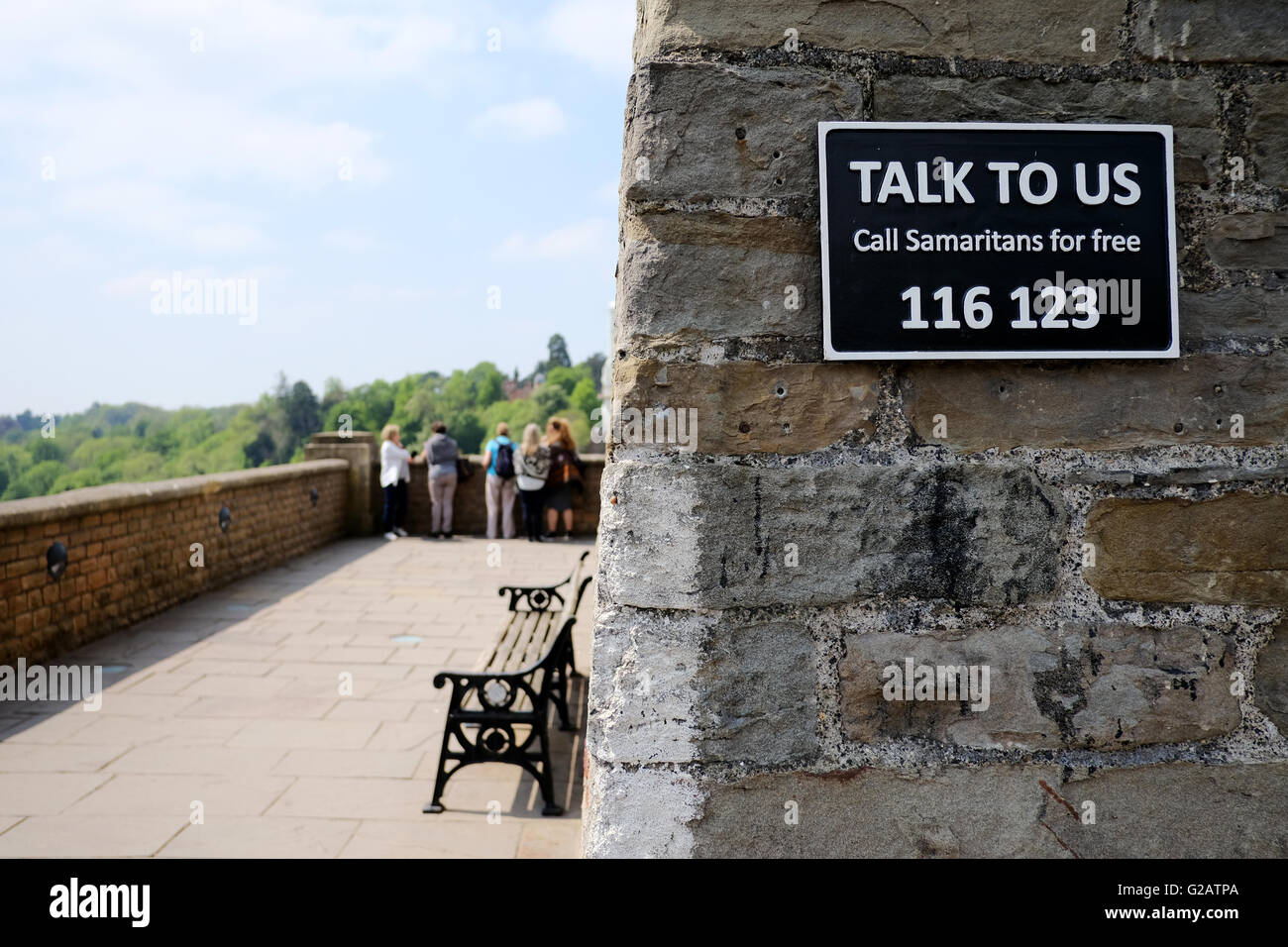 A Samaritans sign on the entrance to a bridge with a telephone number to call for help Stock Photo