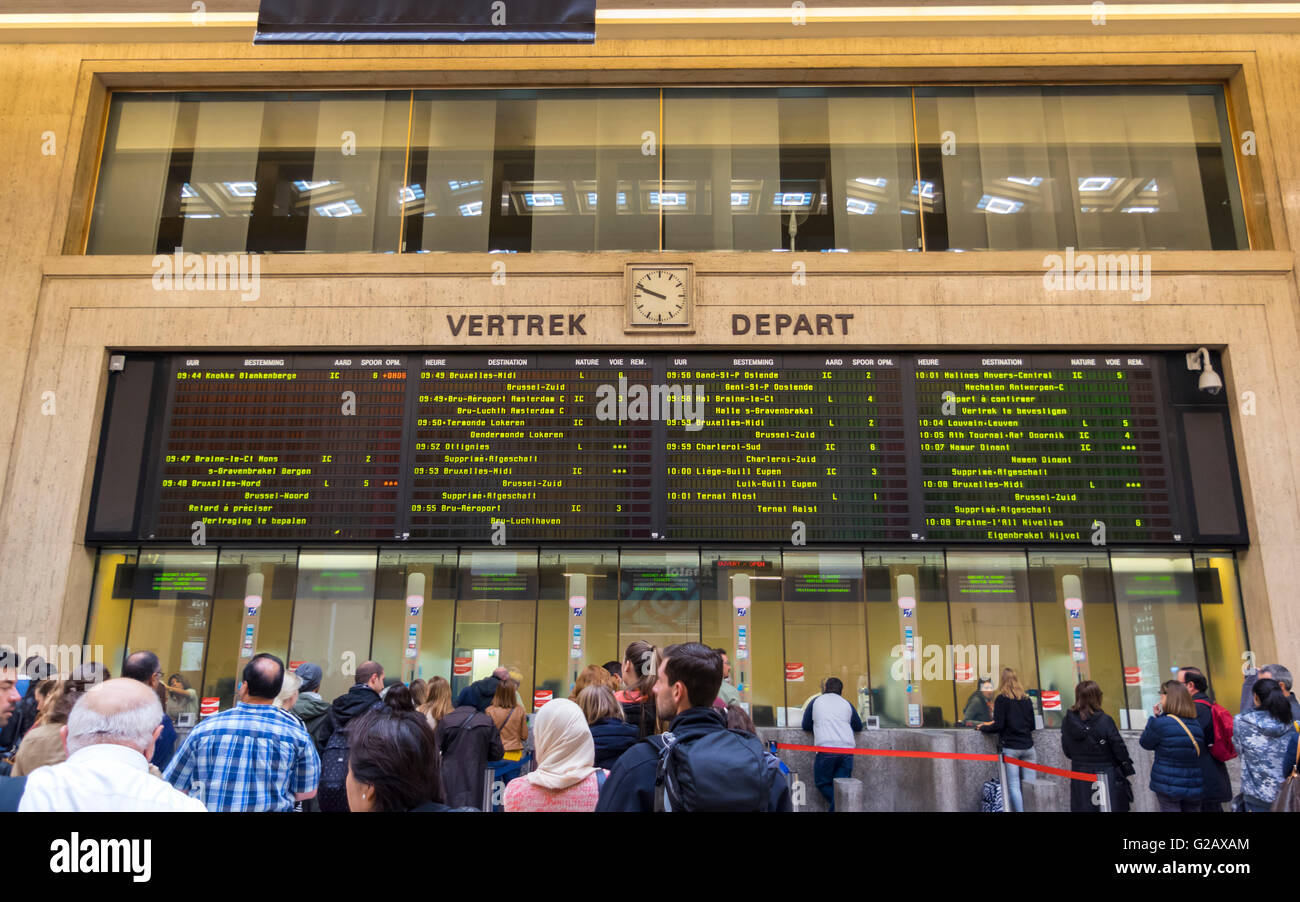 Ticket counters and train departure information board at Brussels main station, showing some trains as being delayed or canceled Stock Photo