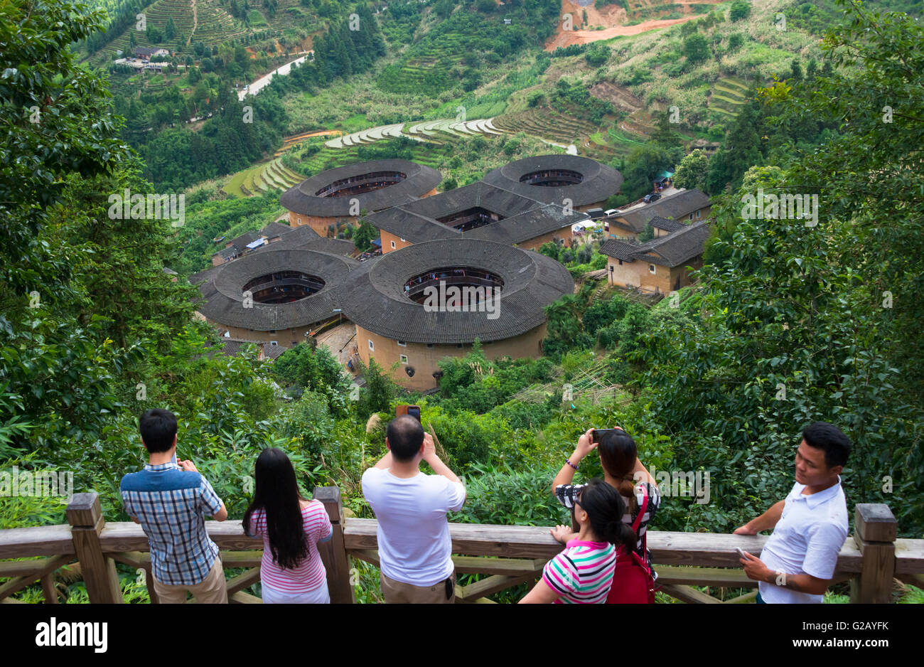 Tourists watching Tianluokeng Tulou, castle houses named Four Dishes and One Soup, UNESCO World Heritage site, Fujian, China Stock Photo