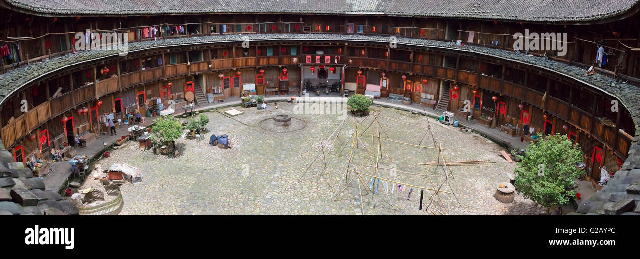 Drying laundry on bamboo sticks in the courtyard of a Tulou, UNESCO World Heritage site, Nanjing County, Fujian Province, China Stock Photo