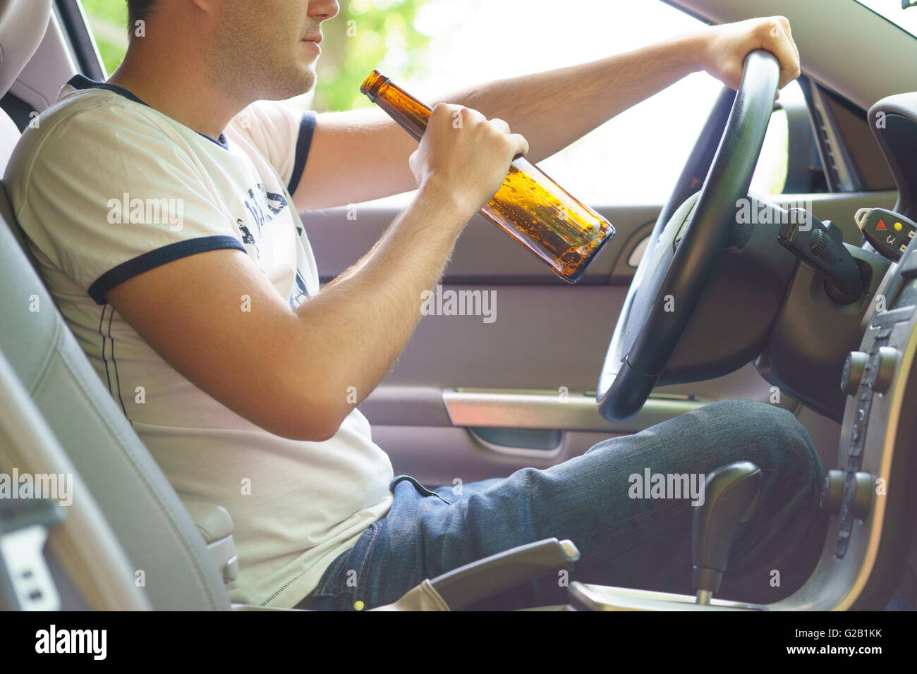 Man drinking beer while driving the car Stock Photo Alamy