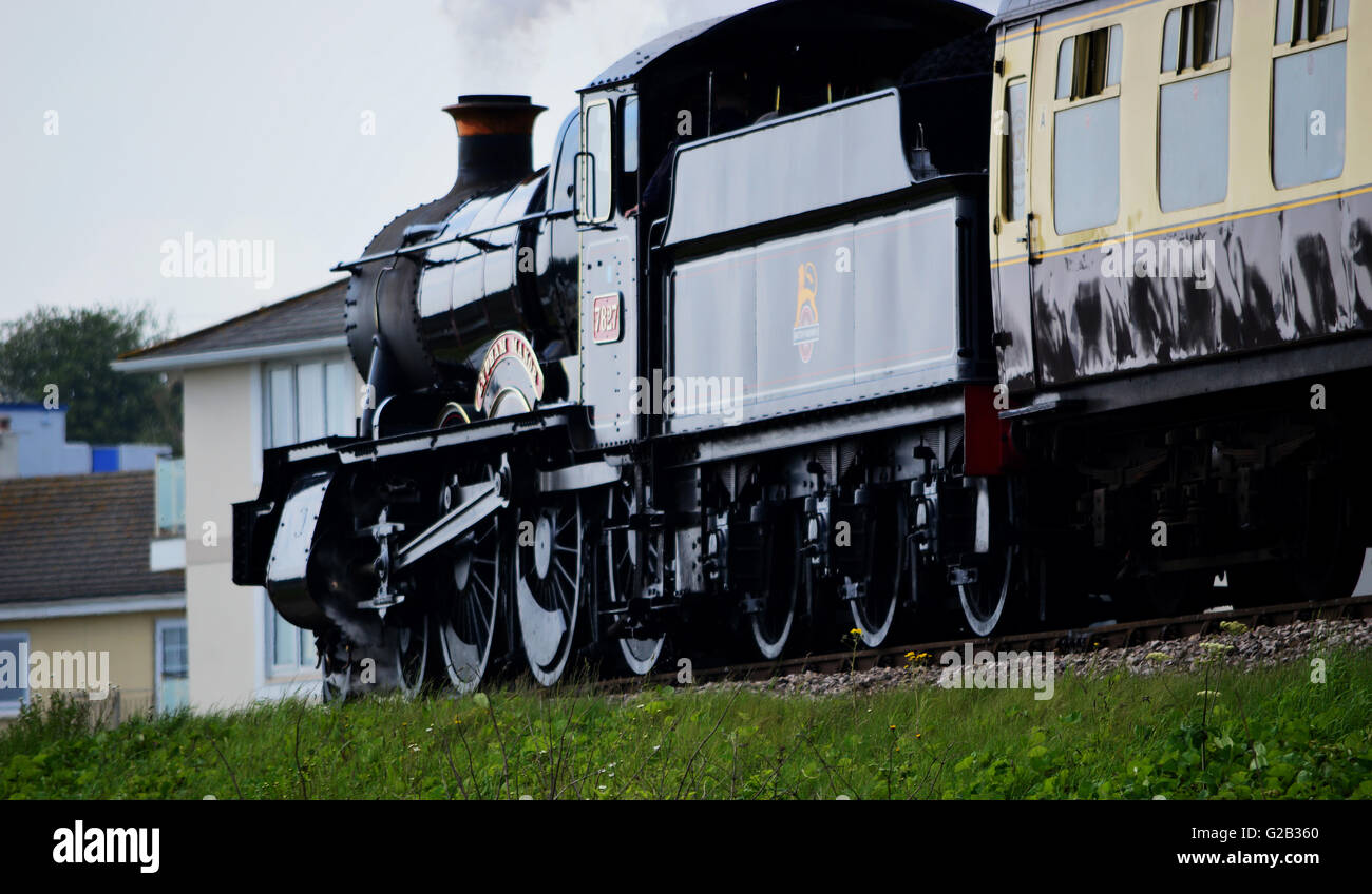 Lydham Manor 7827 steam engine above beach huts at Goodrington, Torbay, Devon, England Stock Photo