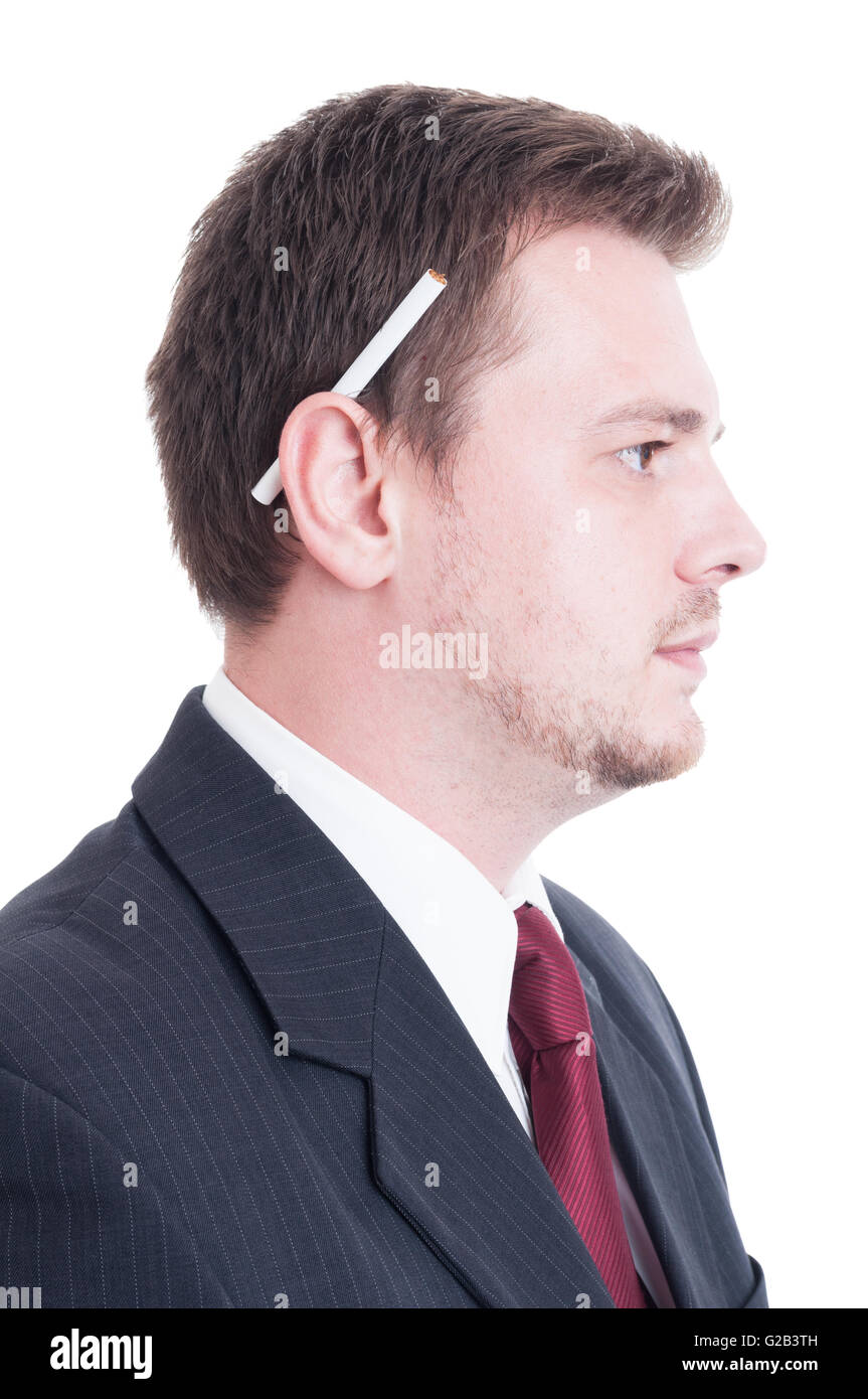 Suited man holding a cigarette behind ear. Smoker employee concept isolated  on white Stock Photo