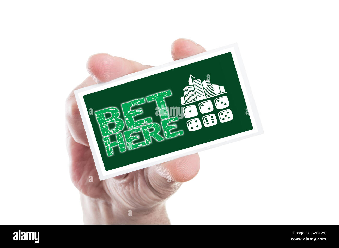Hand holding bet here card as online betting concept with casino shape Stock Photo
