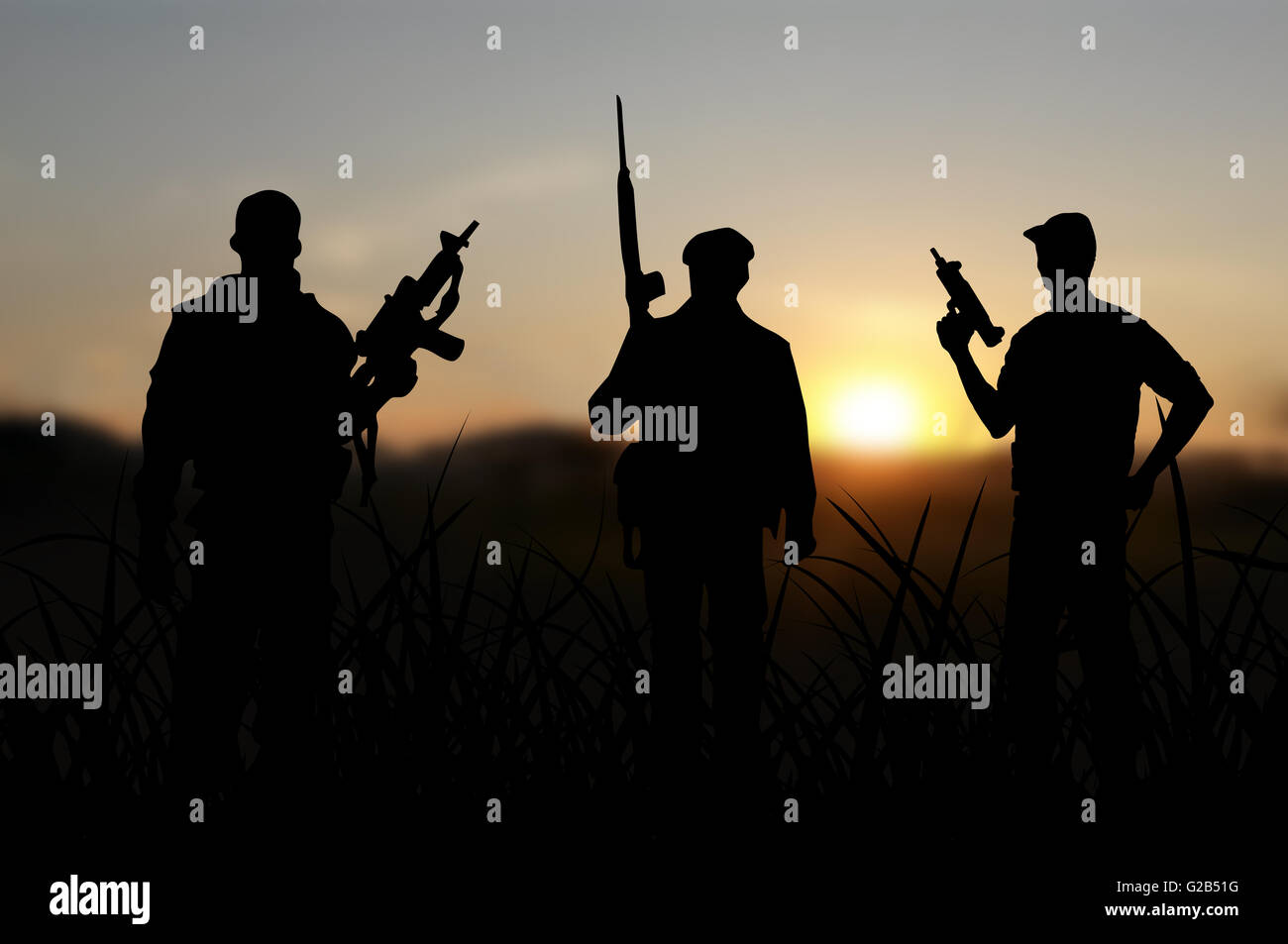 Terrorist or terrorism concept with silhouettes on sunset background Stock Photo