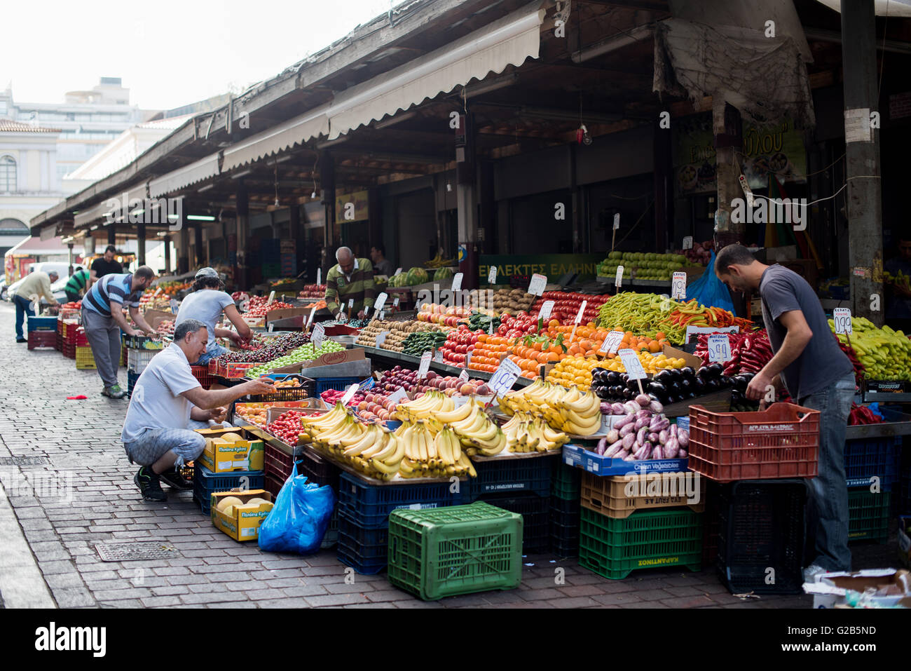 Dimotiki Agora Fresh Produce Market Athens // ATHENS, Greece — Fresh produce for sale at the Dimotiki Agora, also known as Varvakios Agora, in downtown Athens. The market is the largest retail fresh food market in the city, featuring numerous stalls offering a colorful array of local fruits and vegetables. The Dimotiki Agora is a popular destination for locals and tourists, showcasing the abundance and variety of Greek produce. Stock Photo