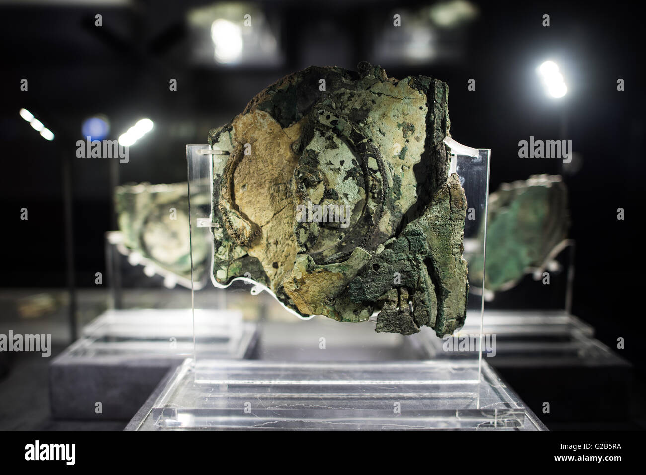 Antikythera Mechanism Fragments National Archaeological Museum Athens Greece // ATHENS, Greece — Original fragments of the Antikythera Mechanism on display at the National Archaeological Museum in Athens, Greece. The ancient Greek astronomical calculator, discovered in a shipwreck in 1900, dates to between 100 BC and 205 BC. The corroded bronze fragments represent the world's oldest known complex astronomical computing device. Stock Photo