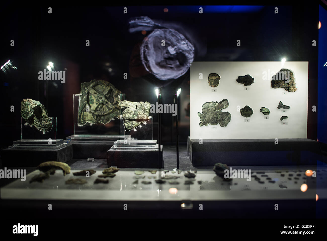 Antikythera Mechanism Fragments National Archaeological Museum Athens Greece // ATHENS, Greece — Original fragments of the Antikythera Mechanism on display at the National Archaeological Museum in Athens, Greece. The ancient Greek astronomical calculator, discovered in a shipwreck in 1900, dates to between 100 BC and 205 BC. The corroded bronze fragments represent the world's oldest known complex astronomical computing device. Stock Photo